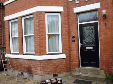 MORTON, WIRRAL. Full design and Installtion of White ash Finish PvcU Vertical Sliding windows, double glazed Carring an "A" Rated Front door is an Apeer D/D double rabetd Composite door with 44mm triple glazeing as standard